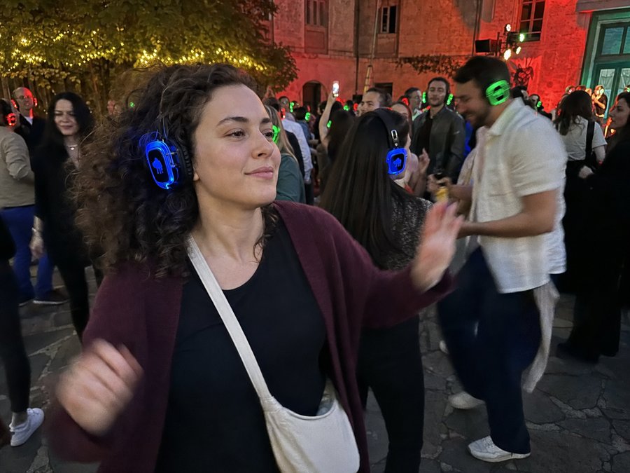 She brought the maroon knit to the silent disco.
