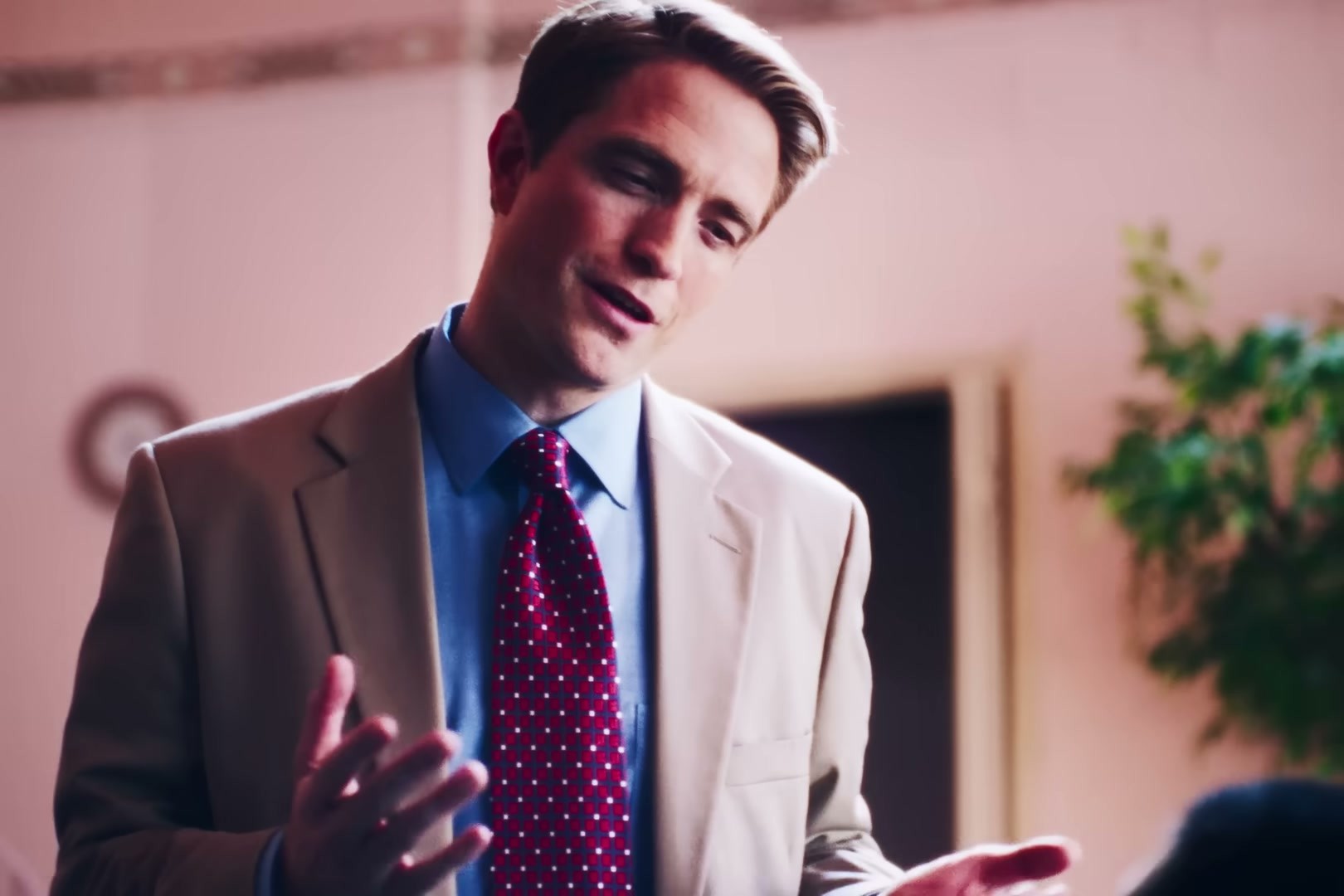 Robert Pattinson in Primetime — tan blazer paired with that blue oxford
