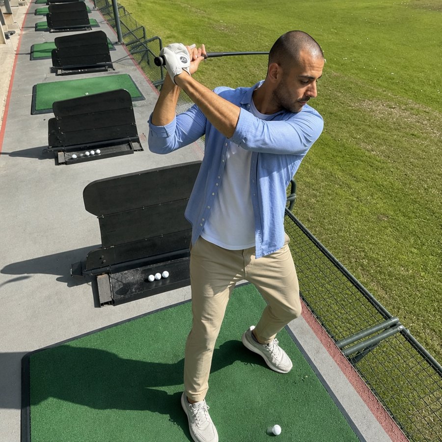 swinging a driver in a button-down is main character energy